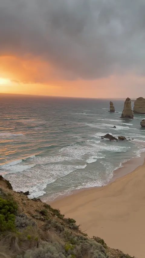 Sunset over the Twelve Apostles sea stacks and waves on the Great Ocean Road