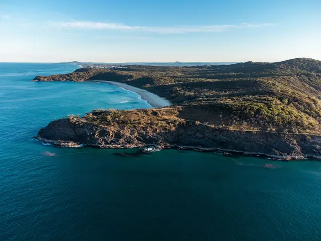 Aerial view of the rocky coastline and blue water of Noosa National Park